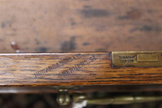 A late Victorian oak pedestal desk, bears Howard and Son stamp and plaque, together with a contemporary black W.150cm